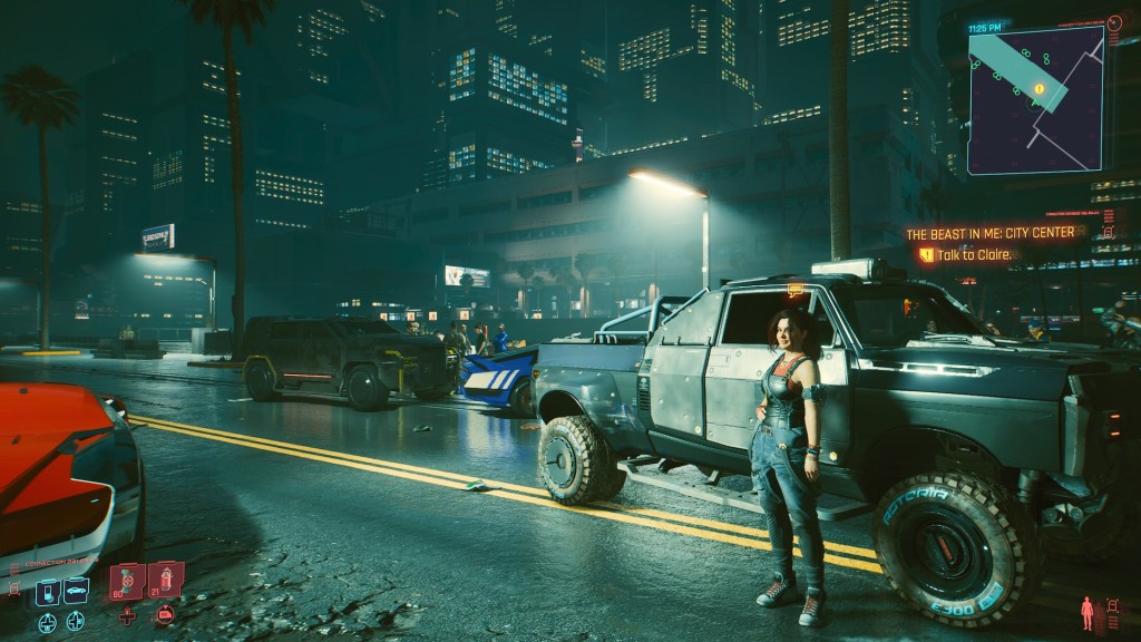 Claire standing next to her truck before a street race. People and cars are on the street.