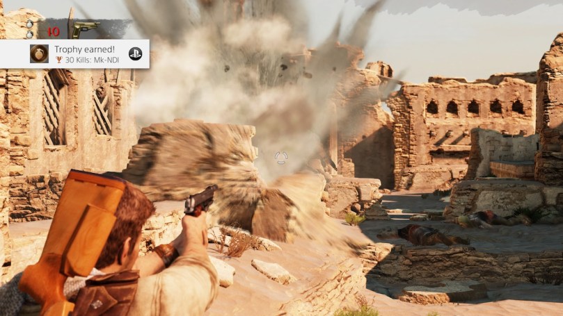 Nate defeating enemies with a grenade in a crumbling desert village ruin.