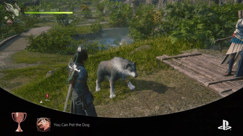 Clive, Jill, and Torgal stand in a lush area with gras fields and small ponds. Clive has pet his dog and the game awarded the player the "You Can Pet the Dog" achievement.