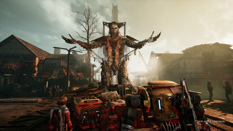 Elvis and Diggs stand in front of a futuristic looking statue in their home town sedentary.