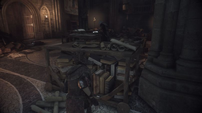 Amicia hiding behind a table of books to avoid being seen by an Inquisition scholar in a ransacked library.